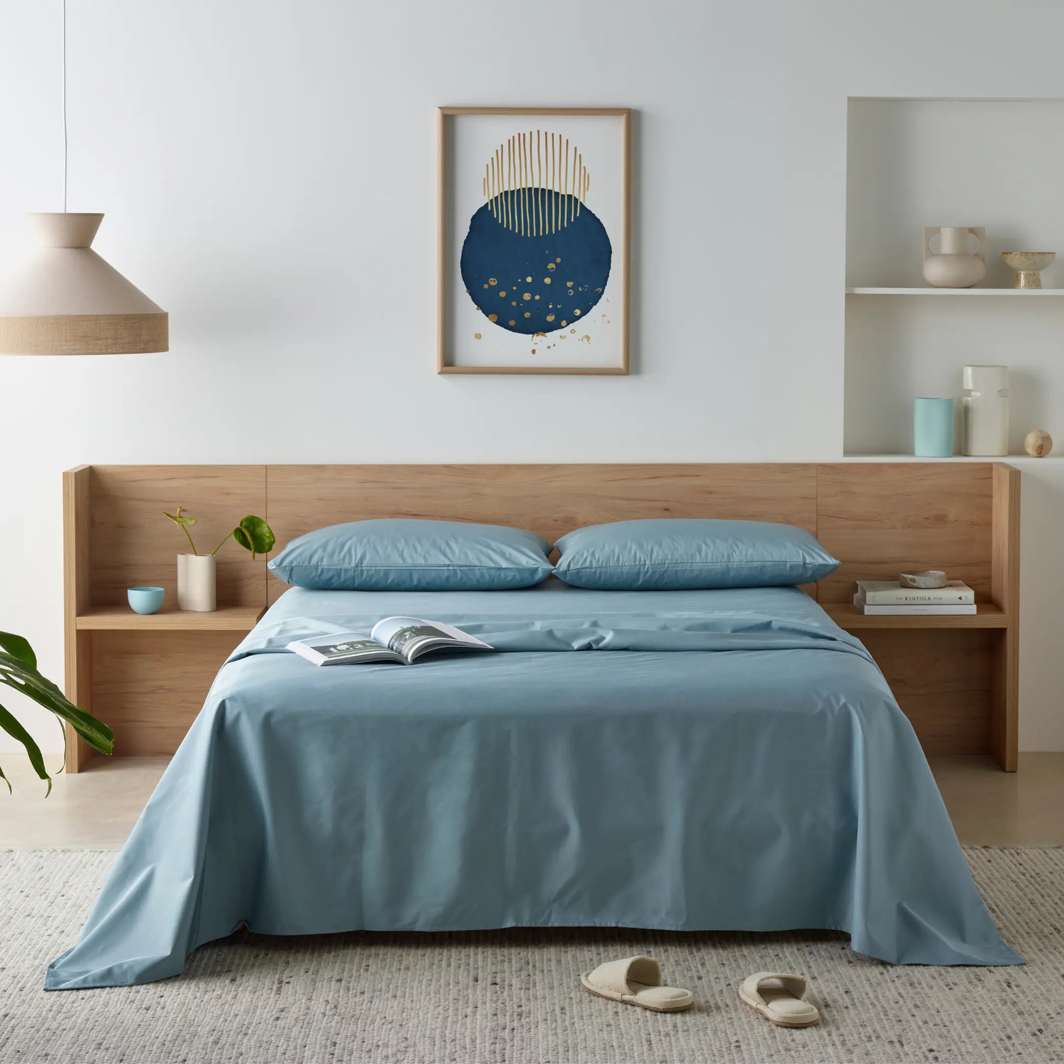 Modern bedroom styled with a blue waterproof bamboo sheet set and matching pillowcases. Designed for softness and breathability, these moisture-resistant, hypoallergenic sheets provide ultimate comfort and spill-proof protection.