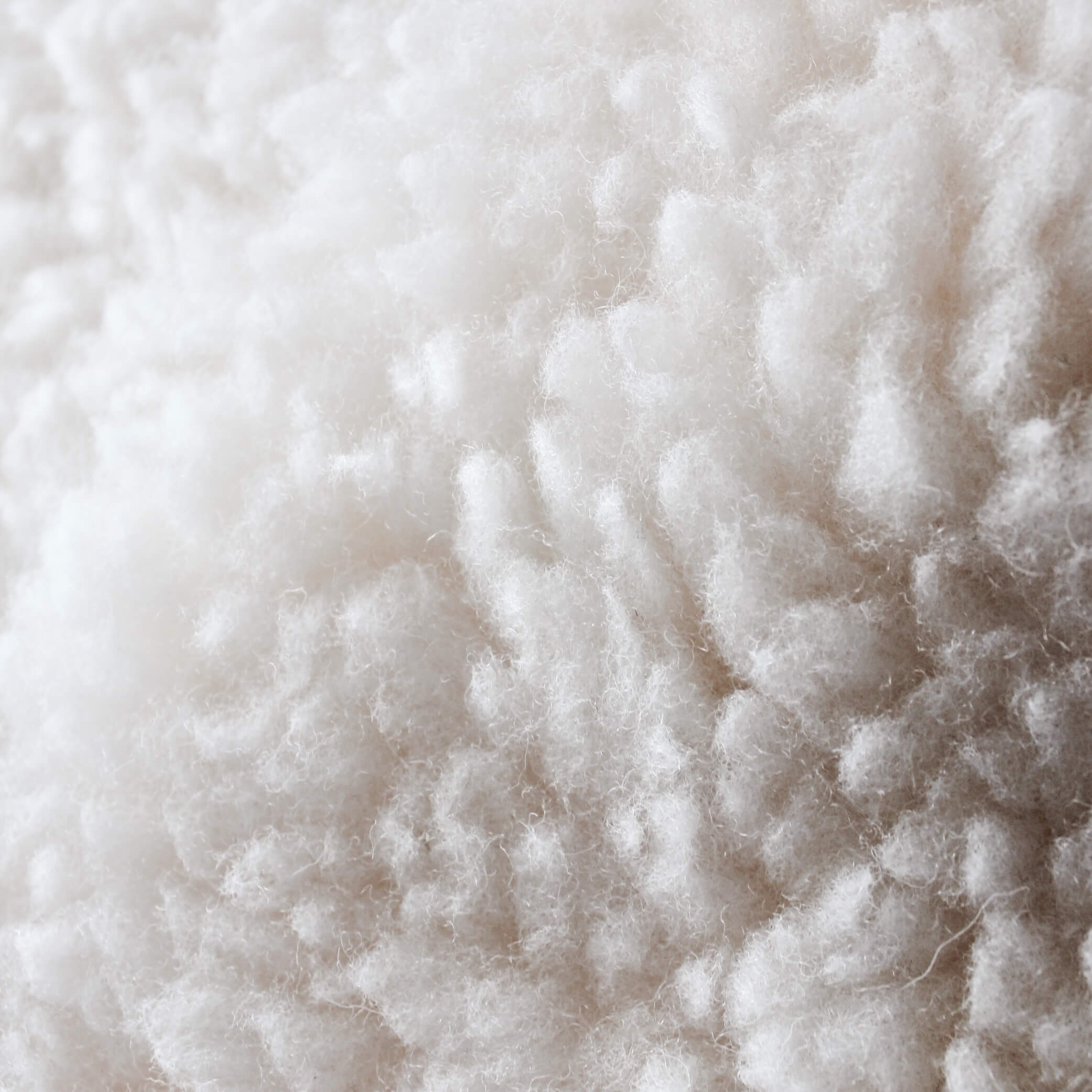 Lambswool up-close cot mattress topper for babies from Staydry.