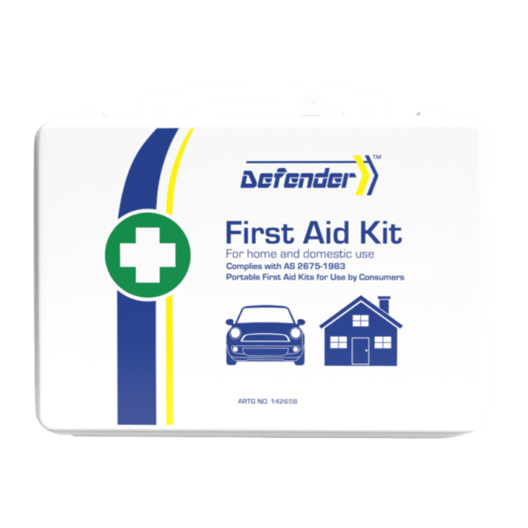 A comprehensive flat-lay product image of the Defender 3 Series Waterproof First Aid Kit contents, arranged around the central white label. Contents include scissors, gauze, rolls of elastic or crepe bandage, surgical tape, ampoules, burn dressing packets, and an emergency thermal blanket, all for treating more serious injuries.