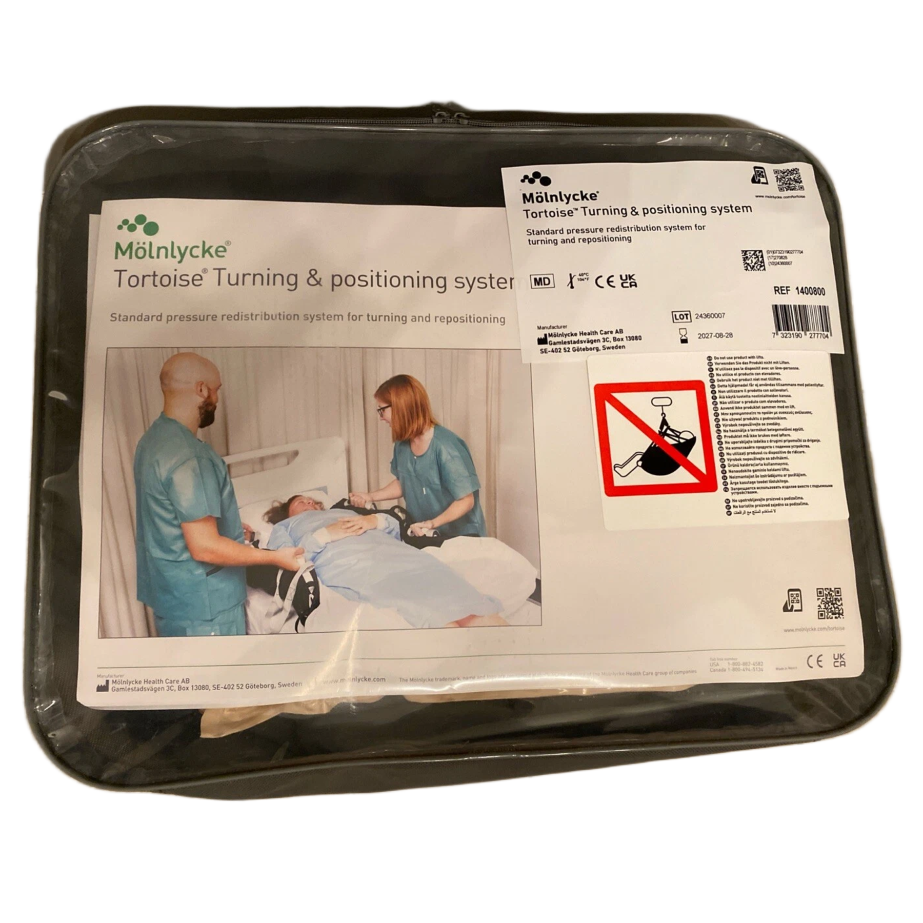 The retail packaging for the Mölnlycke Tortoise Turning and Positioning System, showing a clear plastic carry case with a label depicting two healthcare professionals using the device to reposition a patient in a hospital bed.