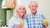 elderly-couple-embracing-holding-glasses-of-fibre-drinks