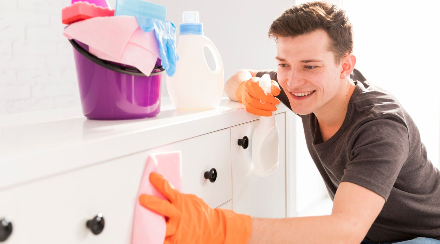 person cleaning their home using enzymatic cleaners