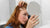 woman looking at the mirror for her eczema on the scalp