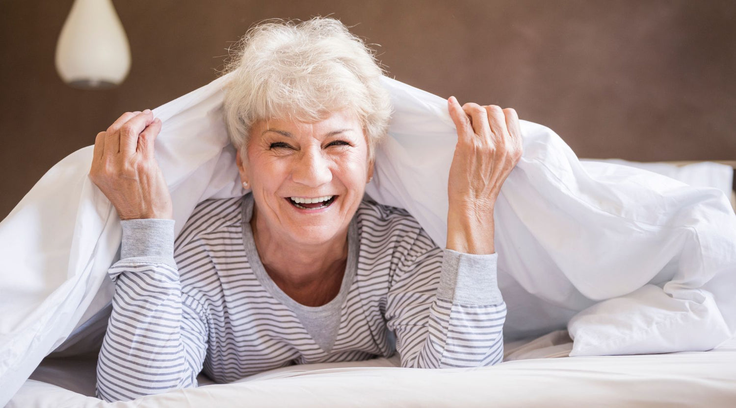 elderly woman happy from using Pressure Care Products to prevent bed sores