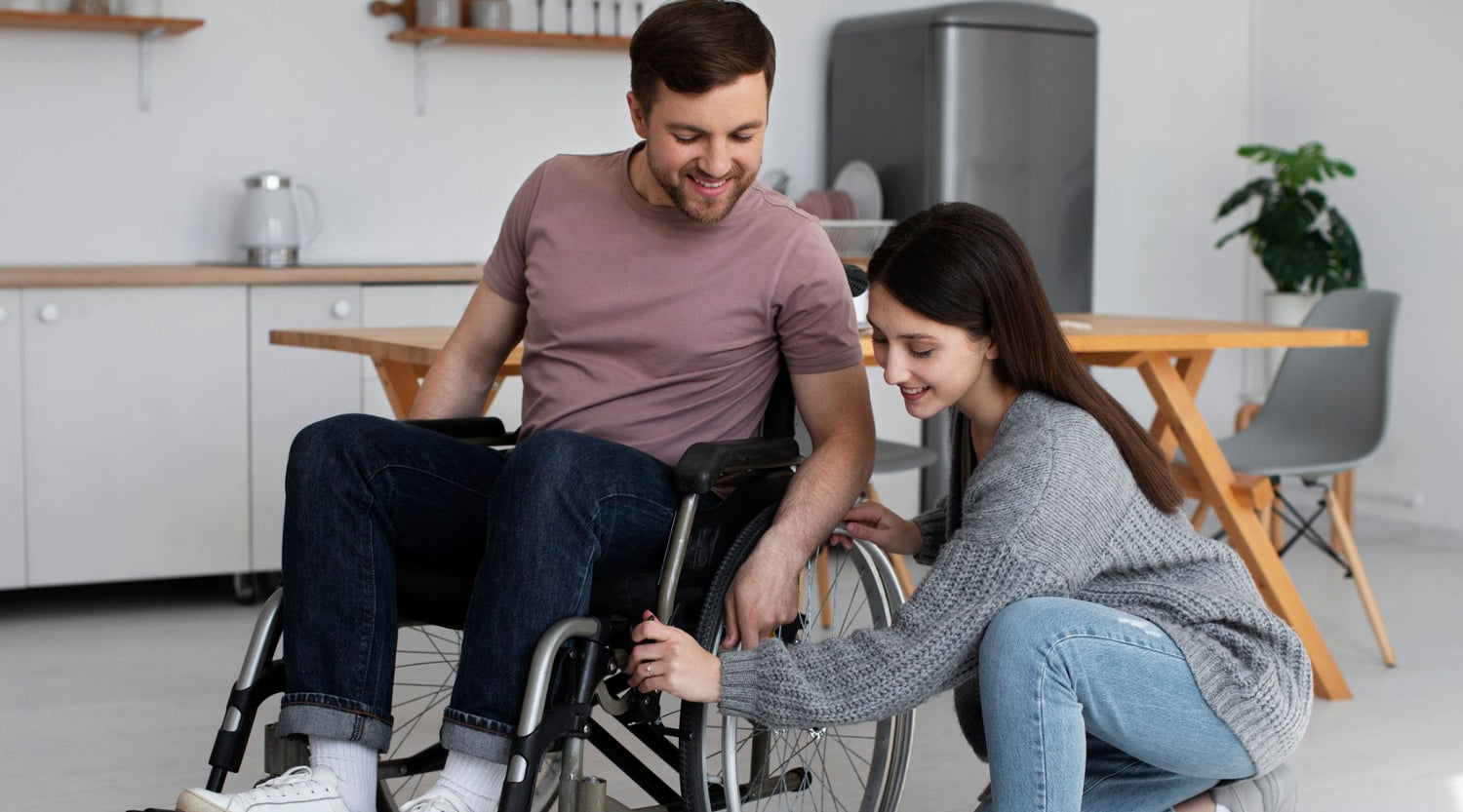 young-adult-helping-disabled-friend maintain and clean wheelchair