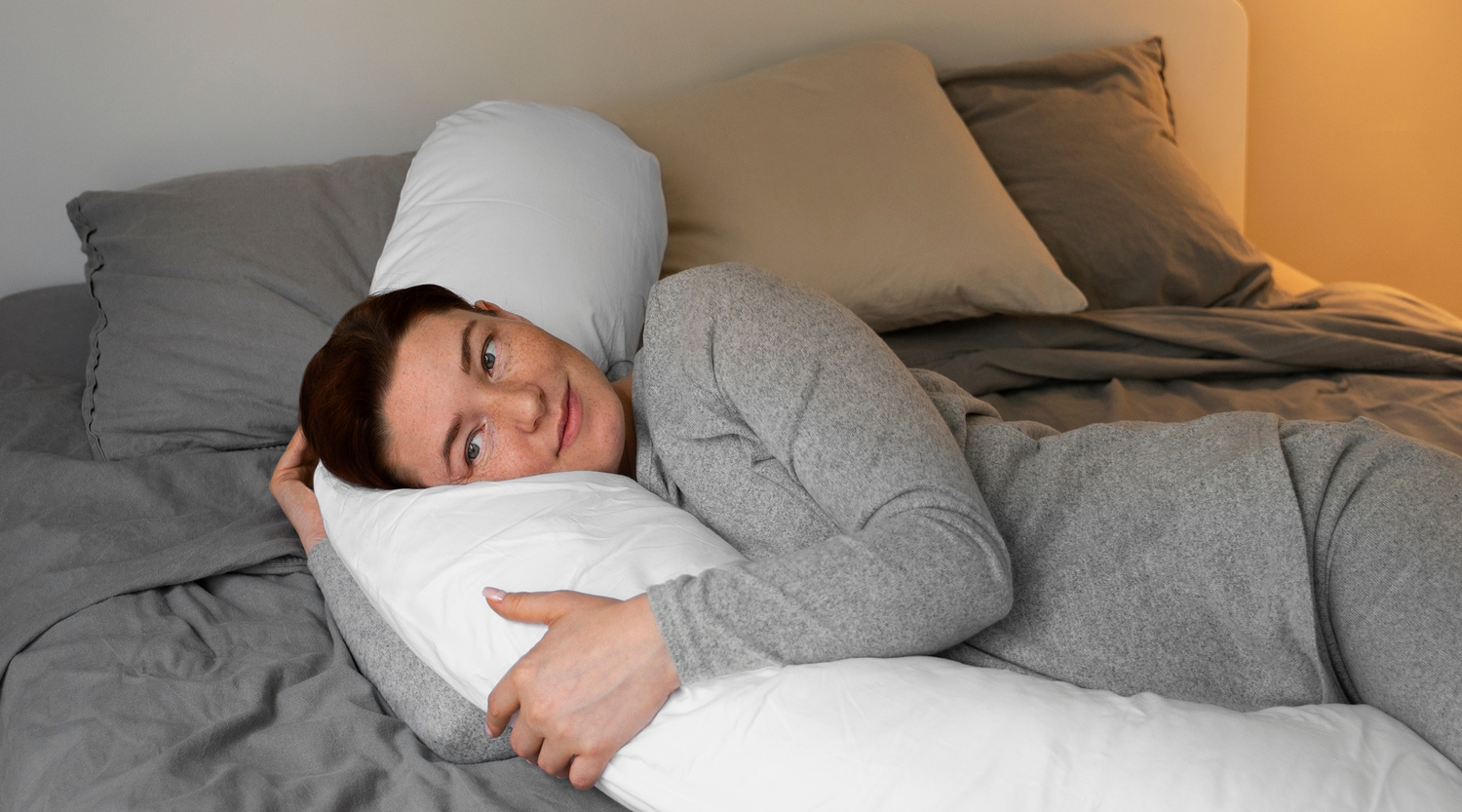 woman carer in bed while being responsible for someone else's sleep