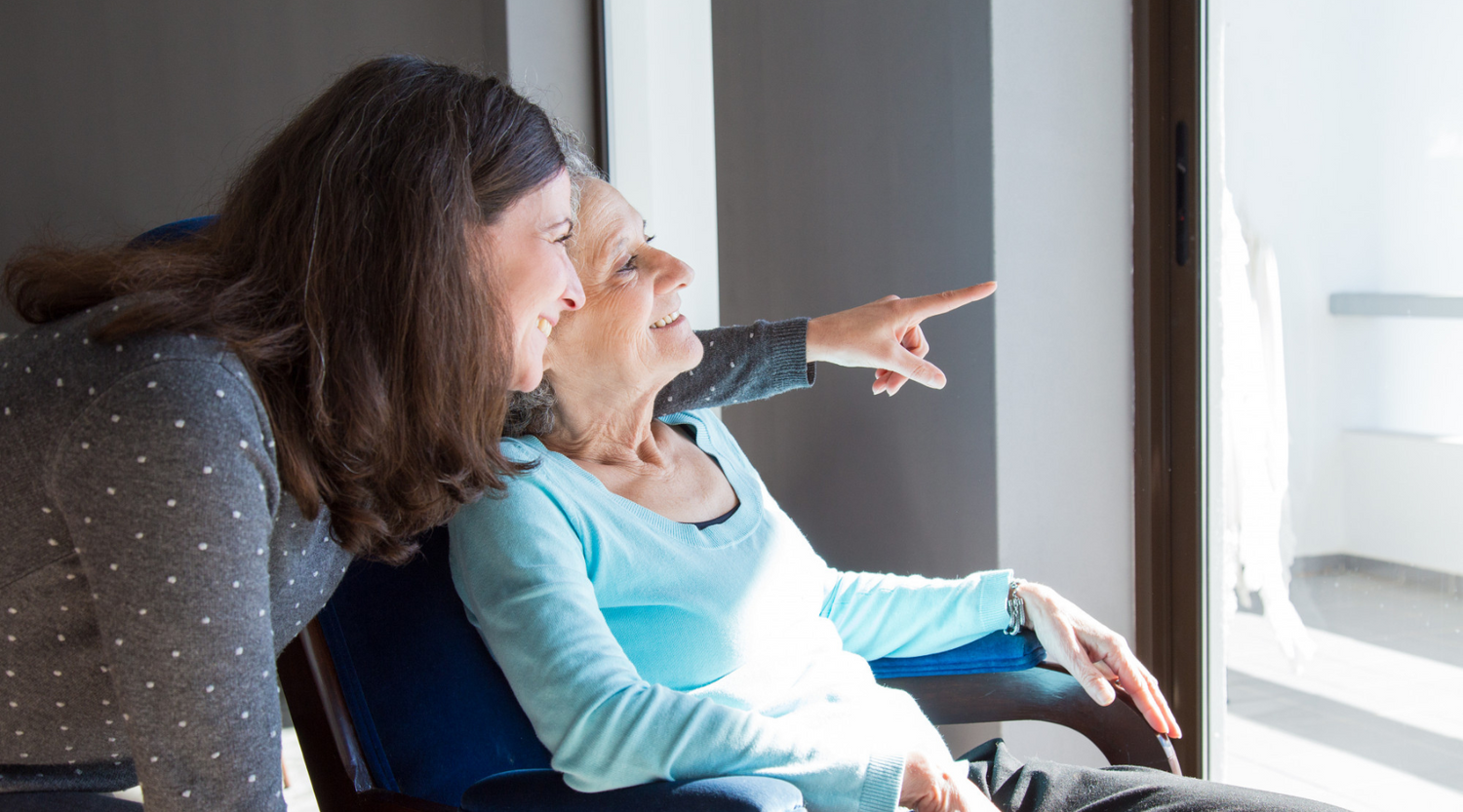 an elderly mother and a daughter enjoying a view
