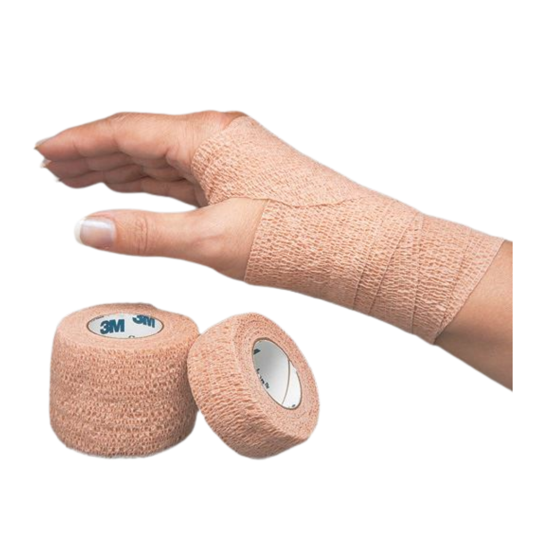 A woman's hand and wrist wrapped in a beige 3M Coban self-adherent elastic cohesive bandage, with two rolls of the bandage in the foreground.