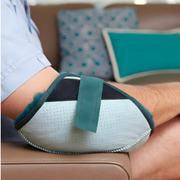 Soft sheepskin elbow protector providing comfort, breathability, and pressure relief for aged care and hospital patients.