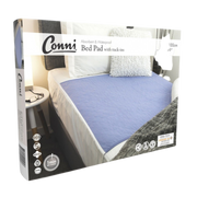 Packaging of Conni Bed Pad with Tuck-ins in mauve color, showing the bed pad on a mattress and details of the product features.