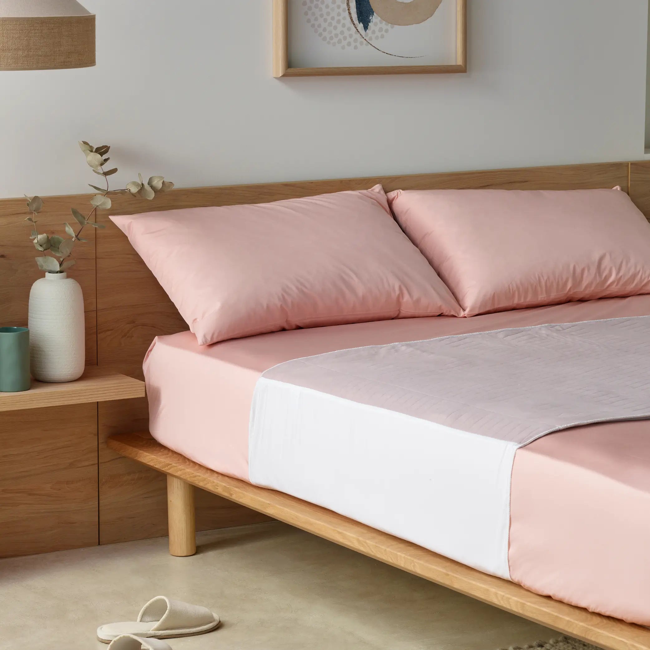 Lilac waterproof bed pad, known as Kylie bed pad elegantly placed on a soft pink bed set. This high-absorbency, reusable incontinence pad provides leak-proof protection while ensuring a comfortable and stylish sleep environment. Ideal for night-time accidents, spills, and mattress protection.