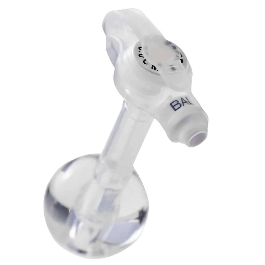 Mic-Key G 18 French low-profile balloon gastrostomy feeding tube with ENFit extension set, showing a flat button-style external port connected to a flexible extension tubing with ENFit connector.