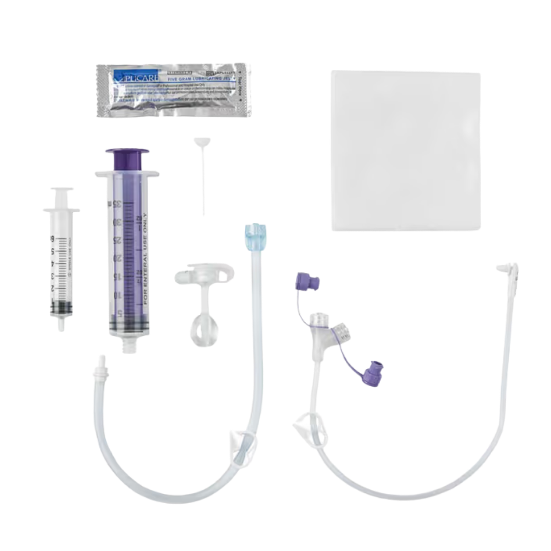 Mic-Key G 24 French low-profile balloon gastrostomy feeding tube with ENFit extension set, medical device designed for enteral feeding, featuring a flat button-style port and detachable extension tubing.