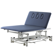 Two-section ComfyCare electric Bobath plinth in navy blue with an adjustable backrest featuring three padded indentations and a white metal frame.