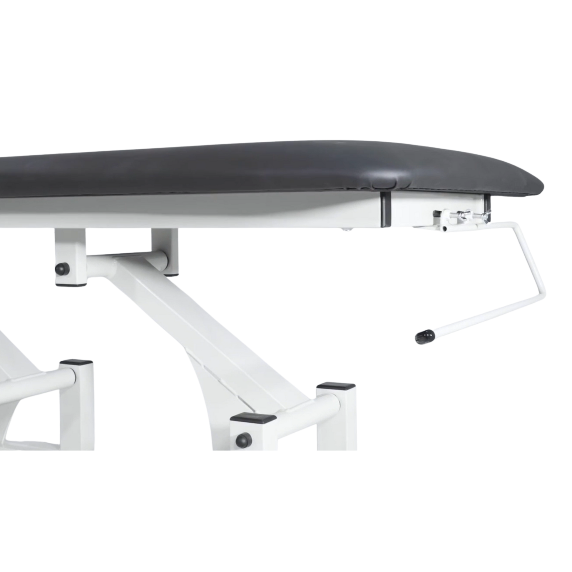 Wide view of a paper towel holder mounted to the frame of an electric treatment couch.
