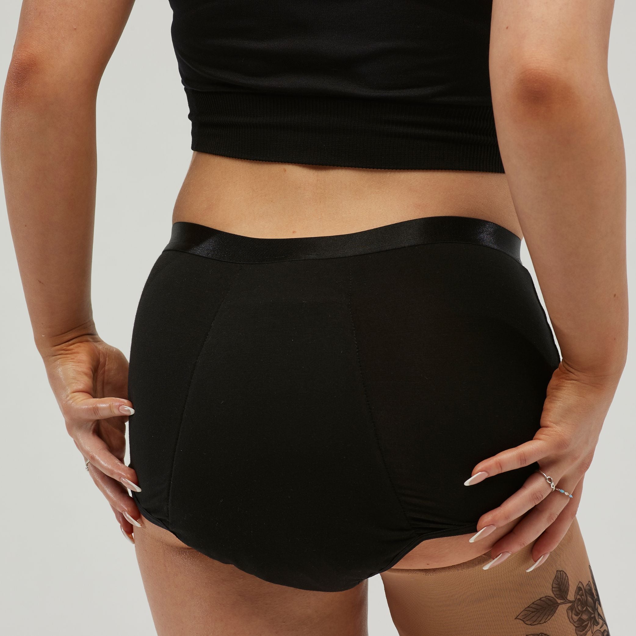 Back view of StayDry women's full brief underwear in black, featuring waterproof and absorbent layers for incontinence protection. High-waisted design ensures full coverage and a secure, leak-proof fit for all-day confidence.