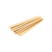 The image shows a stack of wooden tongue depressors arranged in a neat pile. These flat, rounded-end sticks are commonly used in medical and dental examinations to depress the tongue for throat inspection. The natural wood texture is visible, and the background is plain white for a clean, professional look.
