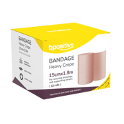 Front view of a white and yellow box of bpositive brand Heavy Crepe Bandages, size 15cm by 1.8m, containing 12 rolls.