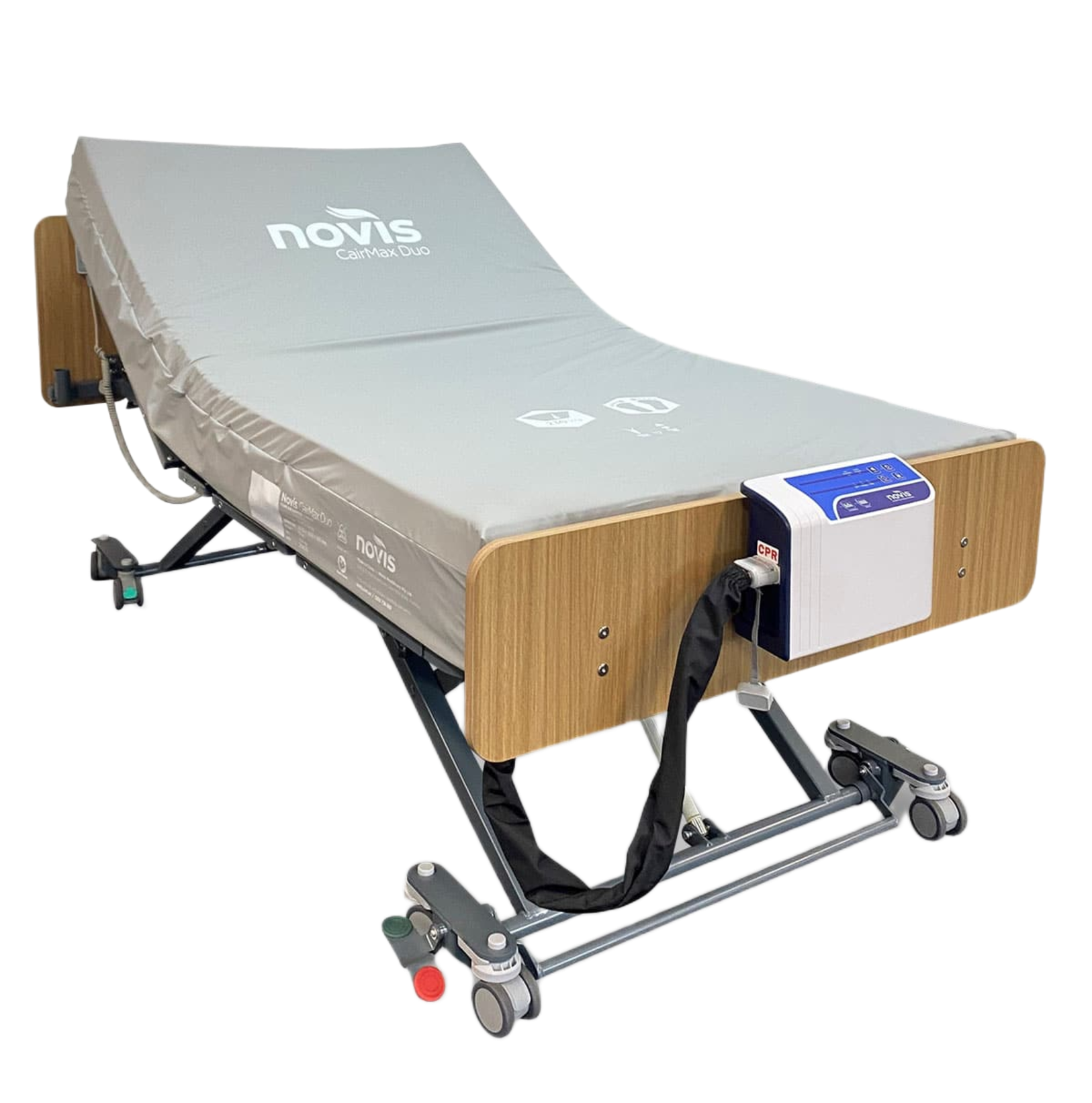 The CairMax Duo King Single mattress installed on a wooden-panel hospital bed frame, showing the pump unit securely attached to the footboard.