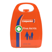 A close-up photograph of the compact, bright orange, plastic case for the Companion 1 Series First Aid Kit. The case features a white first aid cross icon inside a green circle and a blue stripe. White text displays the "Companion" brand name, "First Aid Kit," and "For home and domestic use." It also has a graphic of a family silhouette (two adults and a child) and the regulatory number AR-T-G NO. 142658.