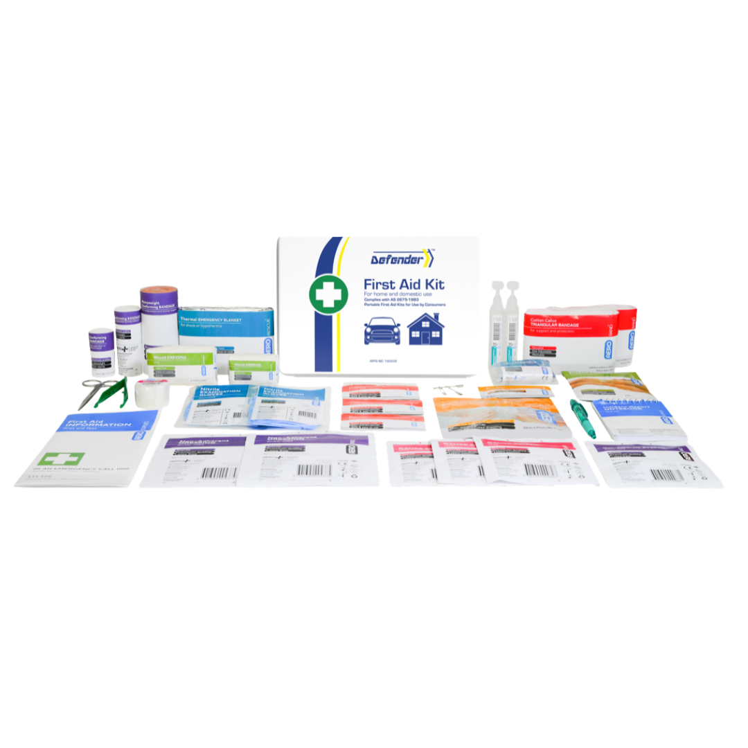 A comprehensive flat-lay product image of the Defender 3 Series Waterproof First Aid Kit contents, arranged around the central white label. Contents include scissors, gauze, rolls of elastic or crepe bandage, surgical tape, ampoules, burn dressing packets, and an emergency thermal blanket, all for treating more serious injuries.