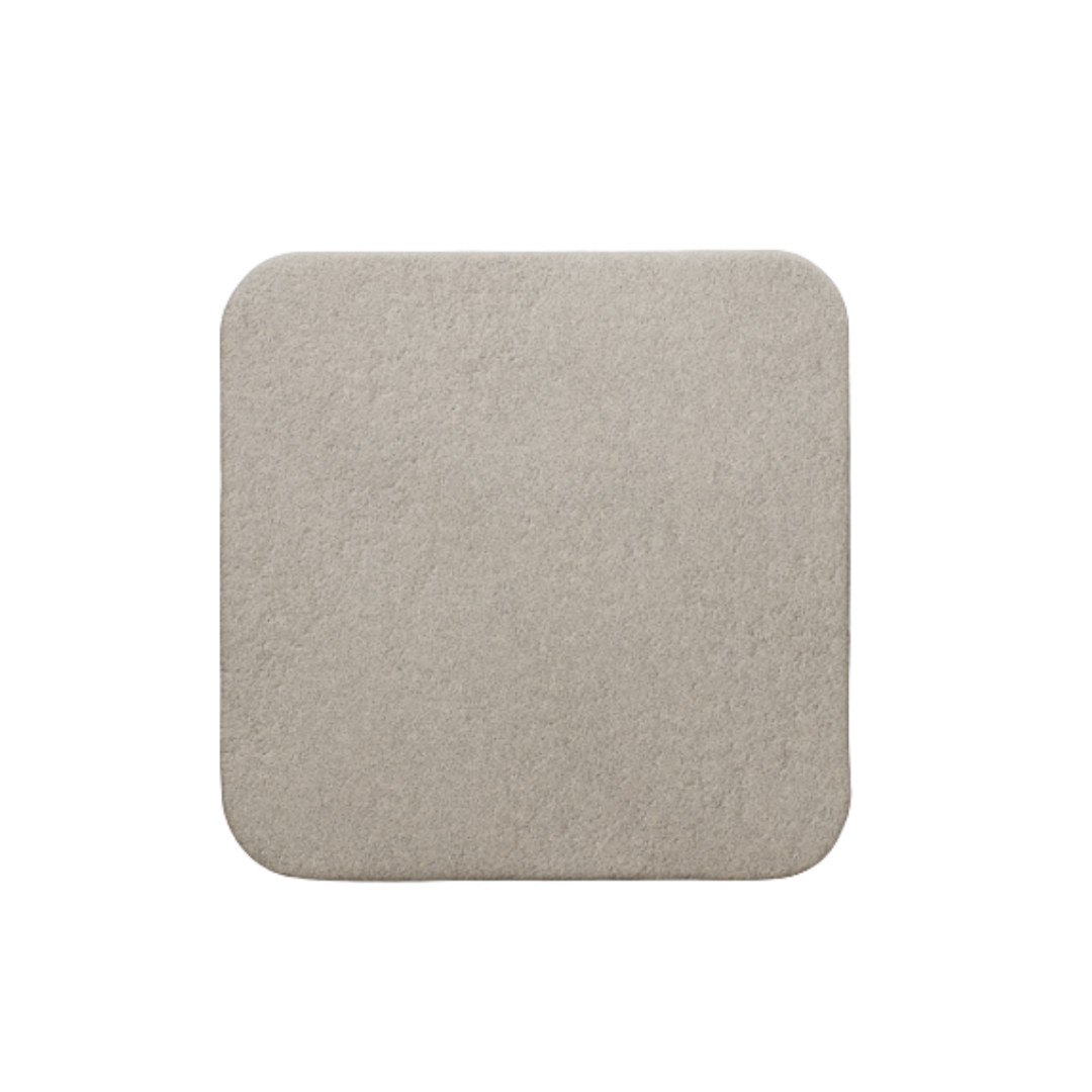 Close-up of a single beige square Mölnlycke Mepilex Border Ag foam dressing pad.