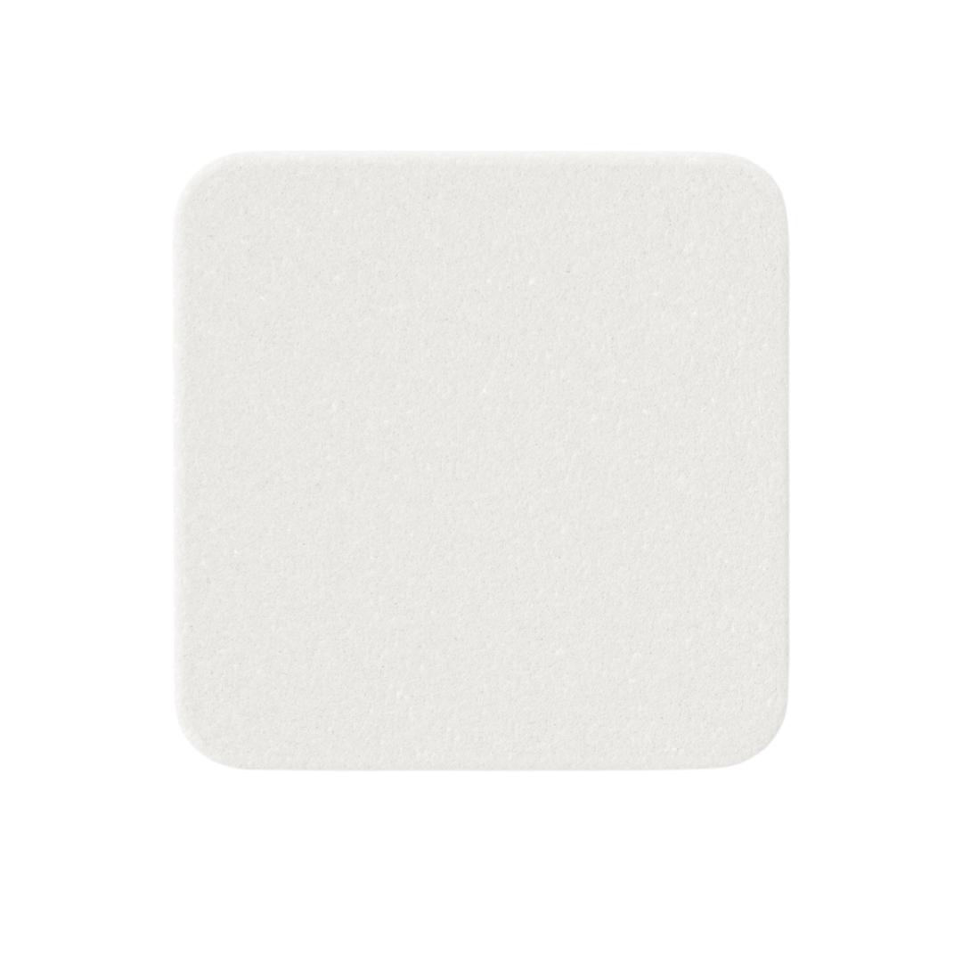Close-up of a single white, square Mölnlycke Mepilex soft silicone foam dressing pad.