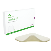 Mepilex XT soft silicone foam dressing shown outside of its white and green 10 x 20 cm packaging.