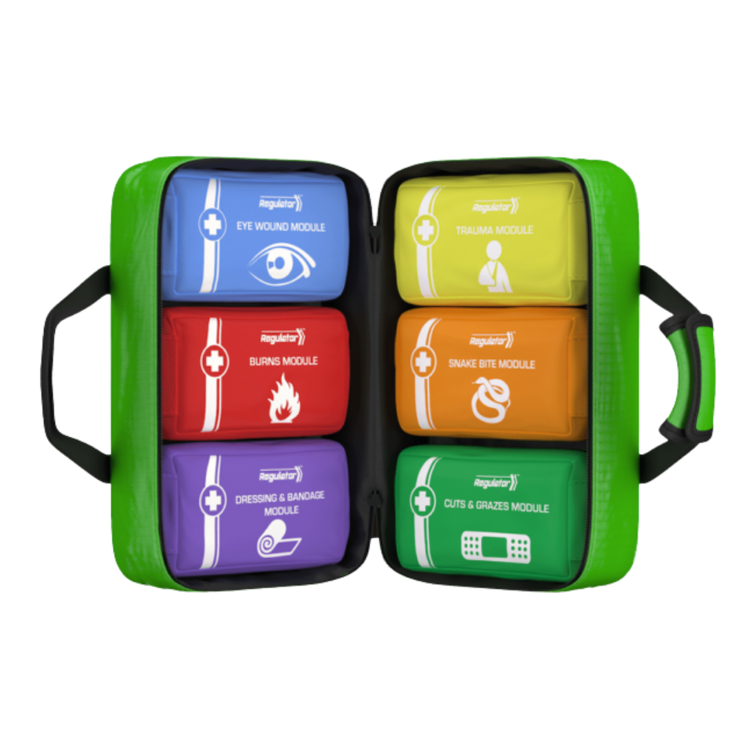 An angled view of the bright green, open Modulator Softpack First Aid Kit. The six color-coded, labeled internal modules are visible, showing their easy-to-read labels and symbols for quick identification: Eye Wound (Blue), Trauma (Yellow), Burns (Red), Snake Bite (Orange), Dressing & Bandage (Purple), and Cuts & Grazes (Green).