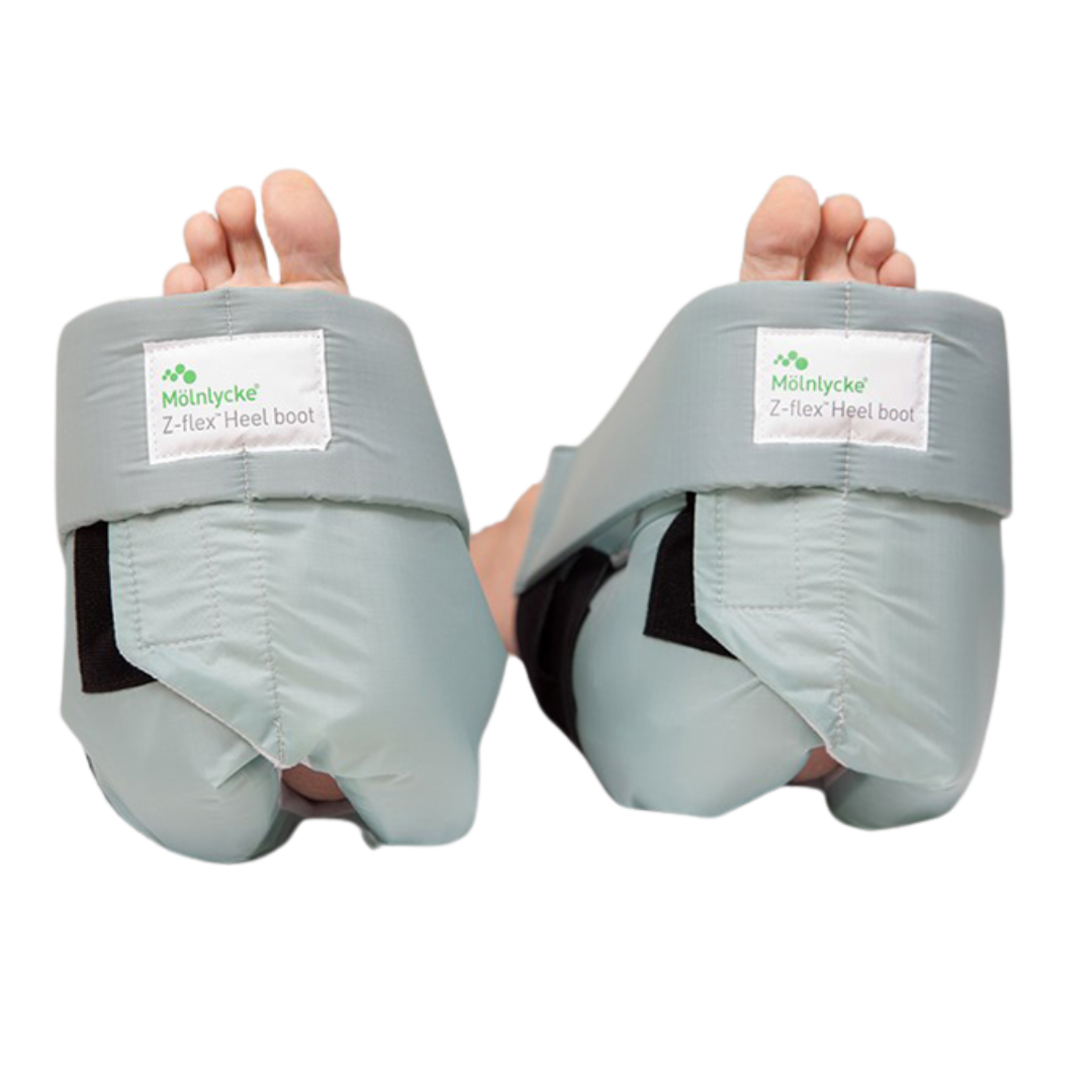 A medical heel protector boot with a soft fabric exterior, integrated air chambers for cushioning, and black Velcro closures.