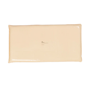 A rectangular, cream-colored Mölnlycke Z-Flo Fluidized positioner pad removed from its packaging, showing the smooth, clean surface of the medical device.
