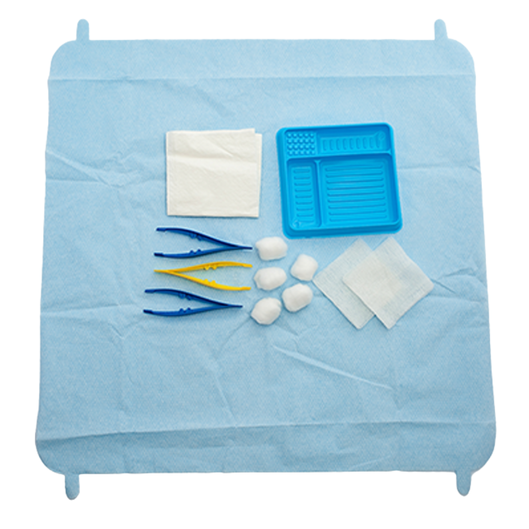 The sterile contents of the Multigate Basic Dressing Pack laid out on the blue sterile field, including a tray, cotton balls, gauze, and three pairs of forceps.