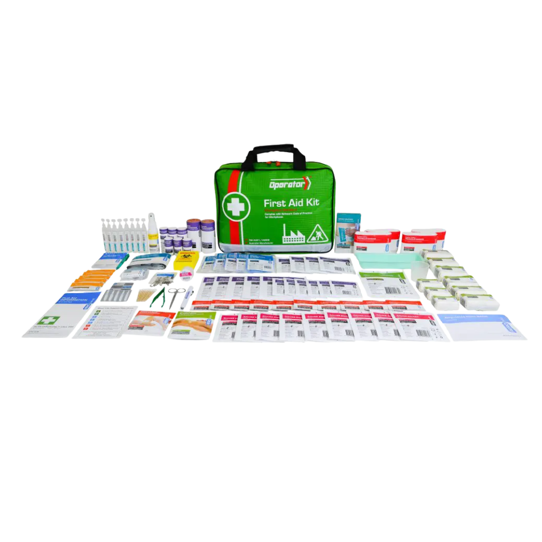 An organized product image showing the comprehensive contents of the Operator Series 5 First Aid Kit laid out on a light background, without the softpack case. The numerous items include saline pods, eye washes, tape, gauze, burn dressings, instruments (scissors, tweezers), and various packaged sterile dressings, suitable for a workplace.